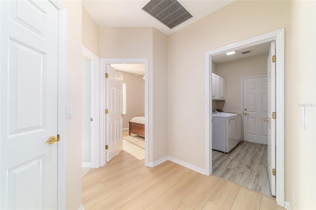9612 Southeast 124th Loop Summerfield, FL 34491 - Photo 40 of 60 a view of a hallway with wooden floor and a bathroom