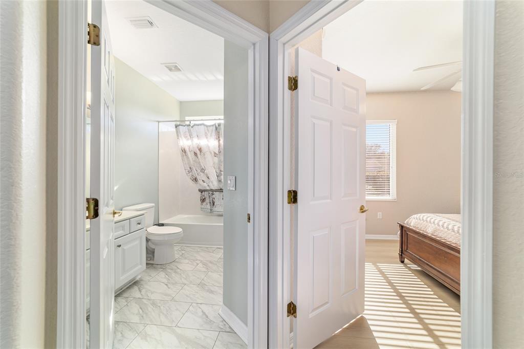 9612 Southeast 124th Loop Summerfield, FL 34491 - Photo 41 of 60 a bathroom with a toilet sink and a mirror