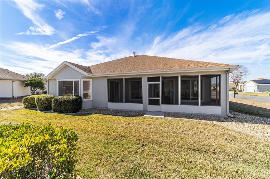 9612 Southeast 124th Loop Summerfield, FL 34491 - Photo 55 of 60 a view of a house with a large window and a yard