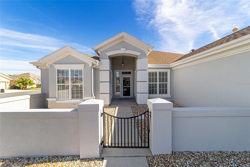 9612 Southeast 124th Loop Summerfield, FL 34491 - Photo 7 of 60 a front view of a house with large windows