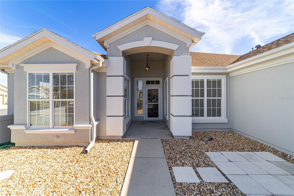 9612 Southeast 124th Loop Summerfield, FL 34491 - Photo 8 of 60 a front view of a house with a rug