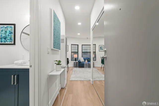 a hallway with a white stove top oven and couches