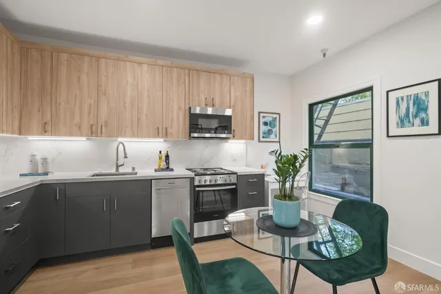 a kitchen with a cabinets appliances and a dining table
