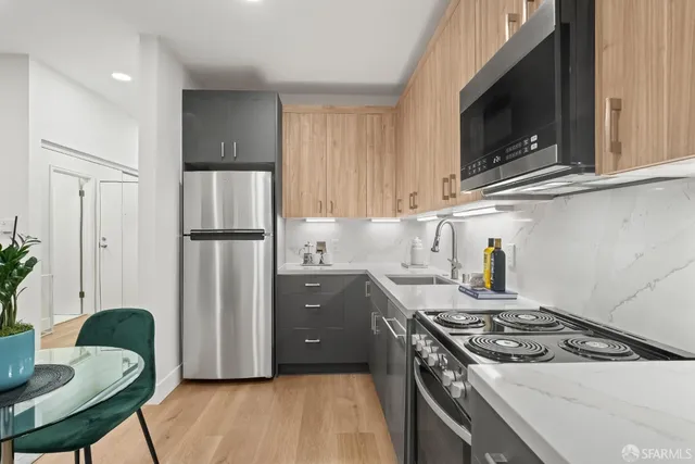 a kitchen with a stove and a refrigerator
