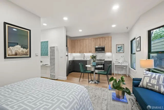 a living room with furniture and painting on the wall