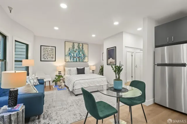 a living room with furniture potted plant and a window