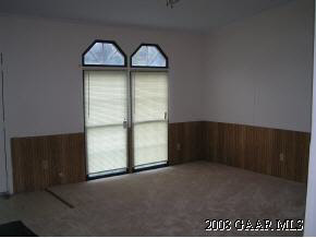 547 Mt Torrey Road Lyndhurst, VA 22952 - Photo 5 of 7 an empty room with wooden floor and windows