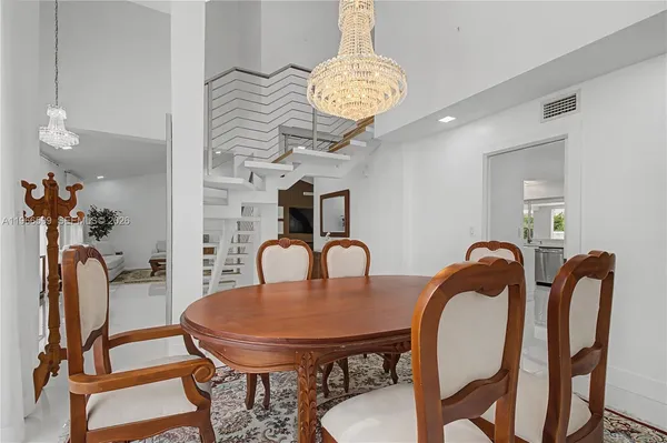 a view of a dining room and hall with furniture
