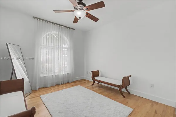 a bedroom with furniture and a window