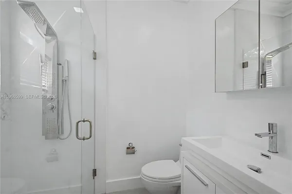 a bathroom with a sink toilet and shower
