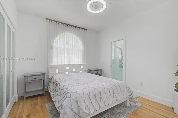 a bed sitting in a bedroom next to a window