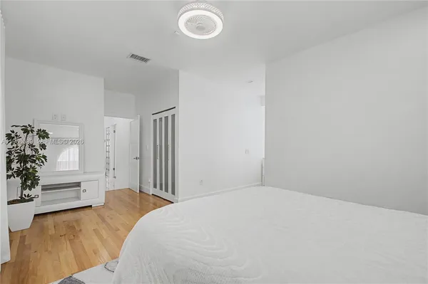 a bedroom with a bed and a dresser