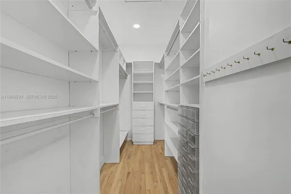 a view of walk in closet with empty racks