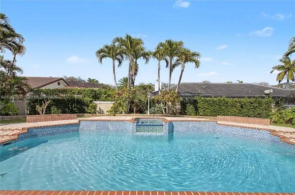a view of swimming pool with outdoor seating and plants