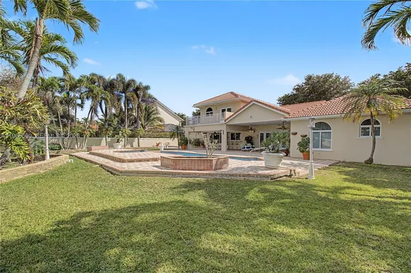 a front view of a house with swimming pool having outdoor seating