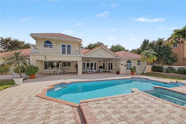 a front view of house with yard and swimming pool