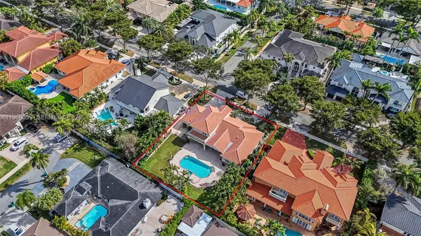 an aerial view of residential houses with outdoor space