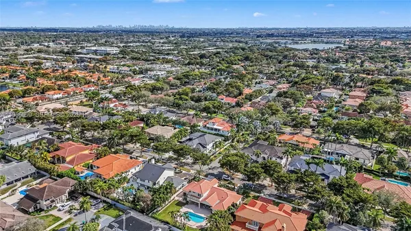 an aerial view of a residential houses with city view