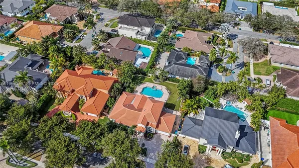 an aerial view of multiple houses with yard