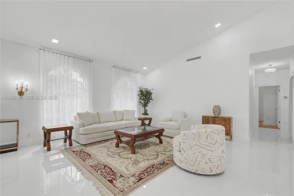 a living room with furniture a rug and a chandelier