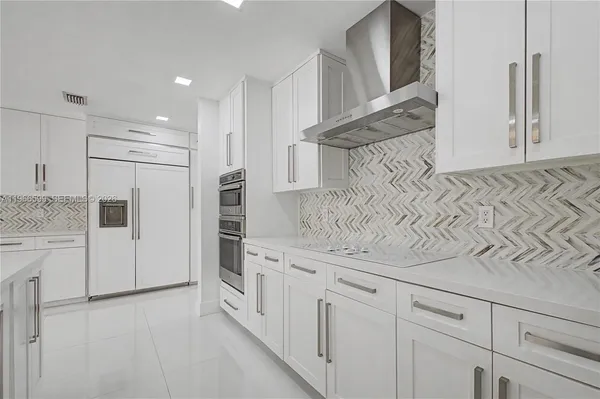 a kitchen with white cabinets and white appliances