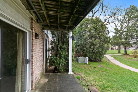 a view of a porch with furniture and a tree