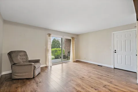 a living room with furniture and a chair