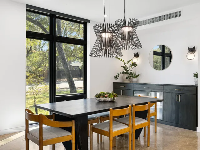 a living room with furniture and a dining table