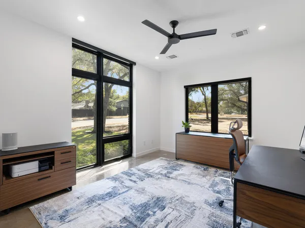 a bedroom with a bed and tv on the dresser
