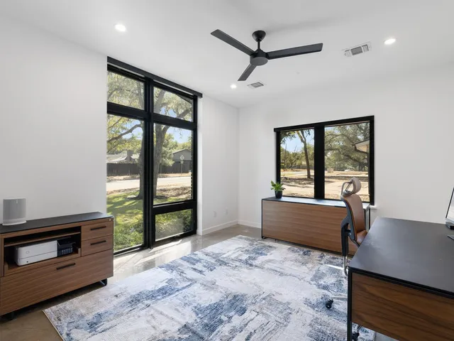 a large bed sitting in a bedroom next to a window