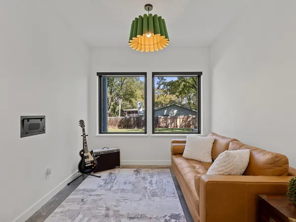 a living room with furniture and a dining table