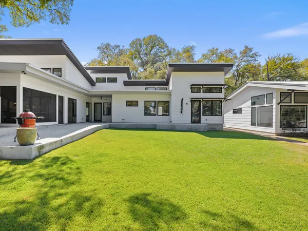 an aerial view of a house with a yard