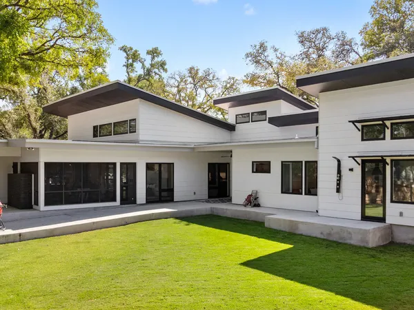a view of a house with pool and a yard
