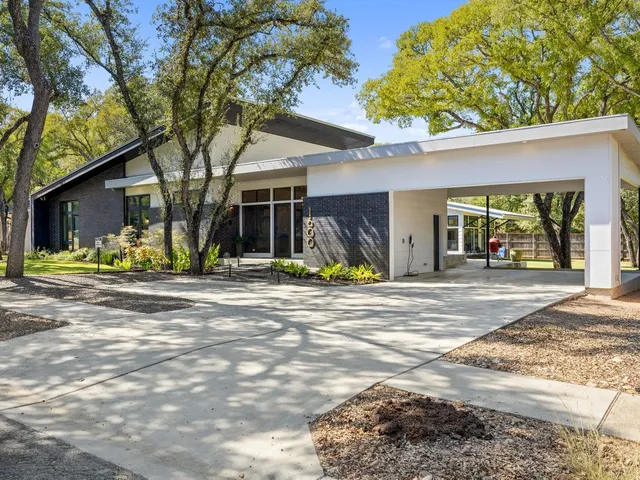 a large kitchen with a stove a sink a refrigerator and a cabinets
