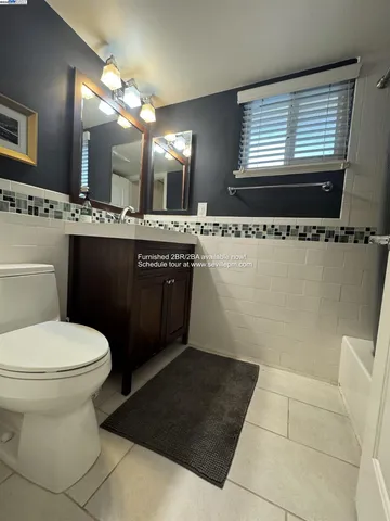 a bathroom with a sink toilet and mirror