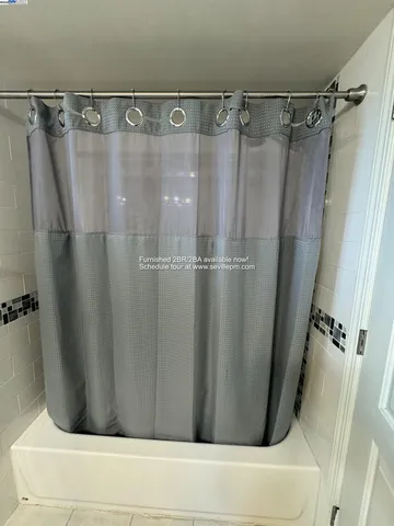 a bathroom with a shower and a tub