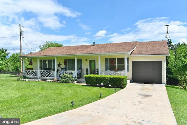 a front view of a house with garden and porch