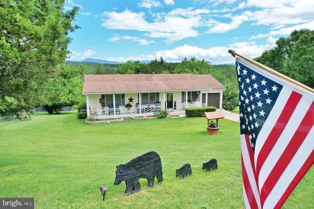 a view of house with outdoor space swimming pool and furniture