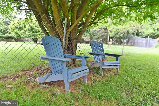 a view of a green field with wooden fence