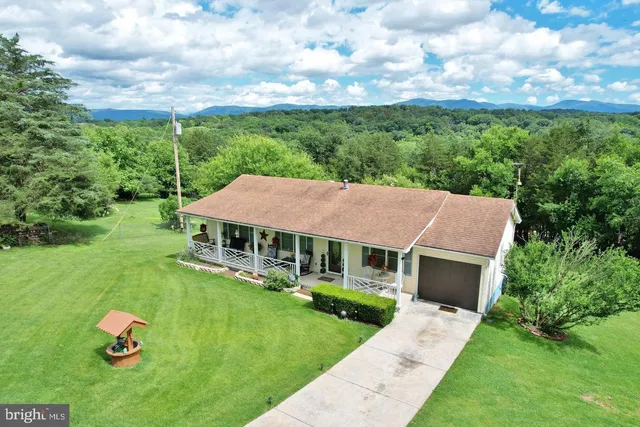 a aerial view of a house with table and chairs