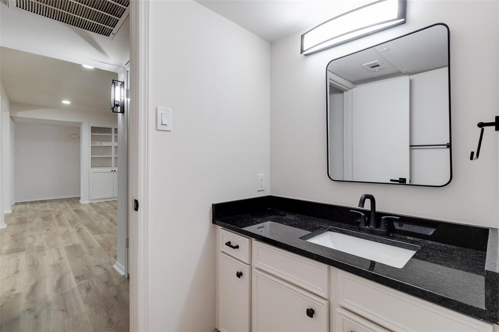 10530 Stone Canyon Road, Unit 208 Dallas, TX 75230 - Photo 14 of 24 a bathroom with a sink and a mirror