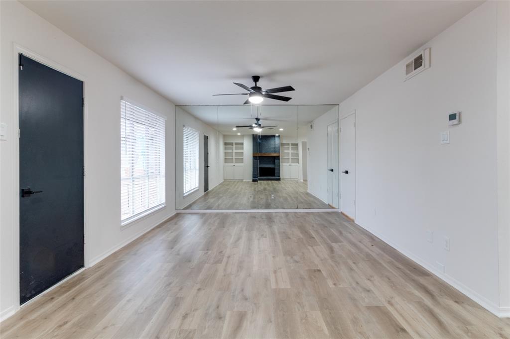 10530 Stone Canyon Road, Unit 208 Dallas, TX 75230 - Photo 6 of 24 wooden floor in an empty room with a window