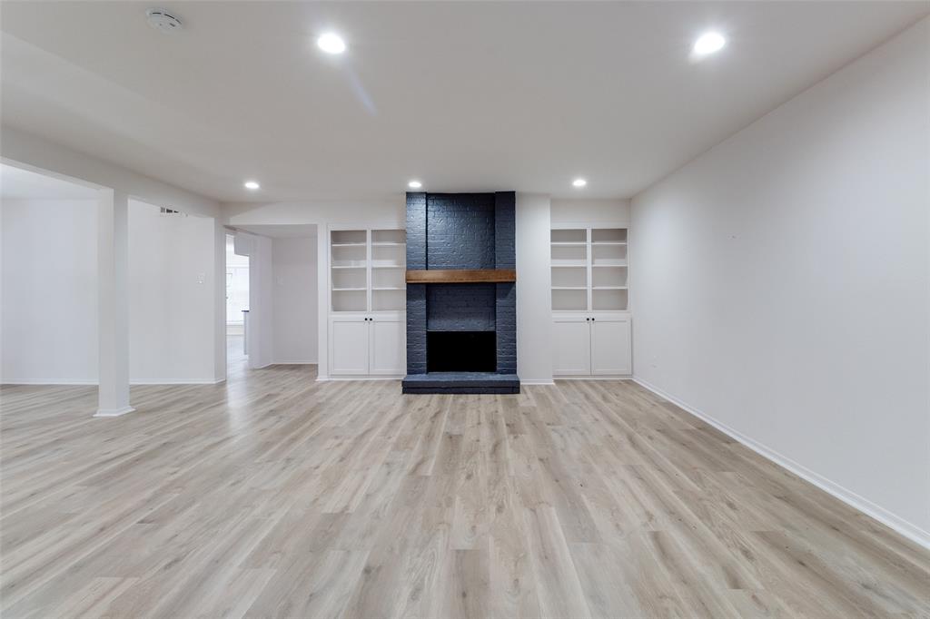 10530 Stone Canyon Road, Unit 208 Dallas, TX 75230 - Photo 9 of 24 a view of an empty room with a fireplace and a window