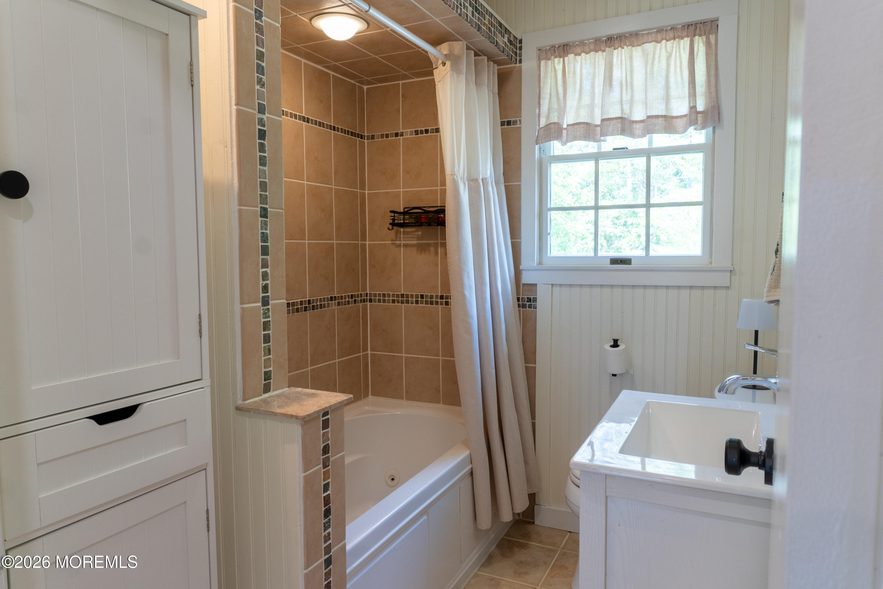 55 Toms River Road Jackson, NJ 08527 - Photo 11 of 31 a bathroom with a tub a sink and a window