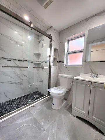 a bathroom with a toilet sink and a shower