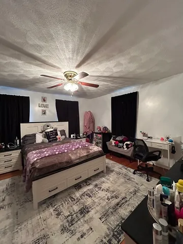 a bedroom with bed and a flat screen tv