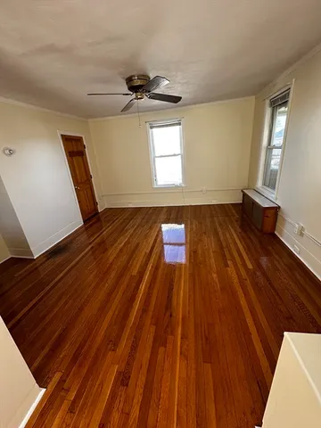 a view of an empty room and wooden floor