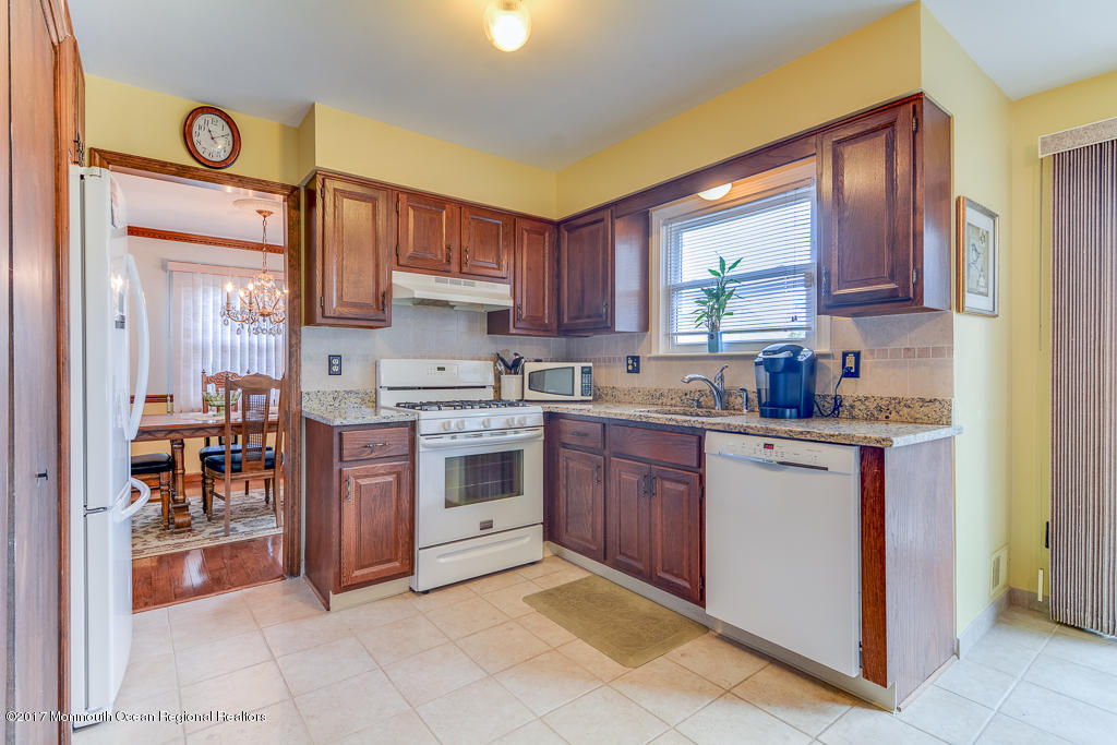 173 Club House Road Brick, NJ 08723 - Photo 17 of 30 a kitchen with stainless steel appliances granite countertop a stove top oven a sink and dishwasher
