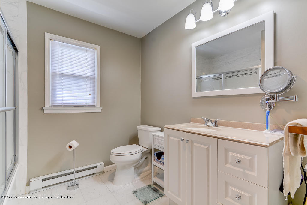 173 Club House Road Brick, NJ 08723 - Photo 29 of 30 a bathroom with a toilet a sink and mirror