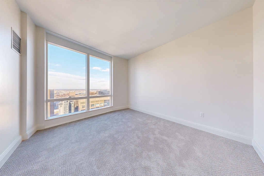240 Devonshire Street, Unit U5401 Boston, MA 02110 - Photo 11 of 41 an empty room with windows and city view